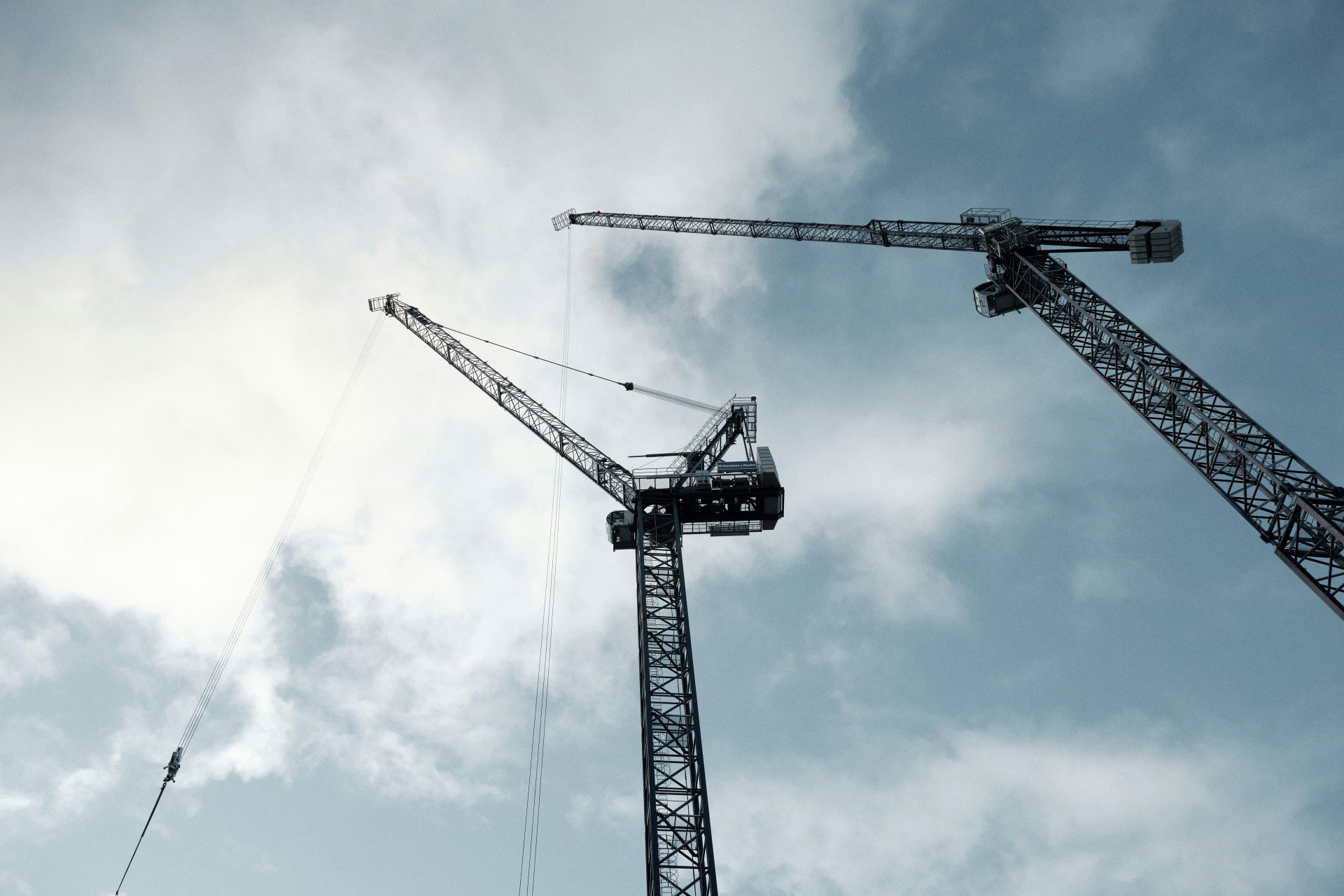 black crane under cloudy sky during daytime